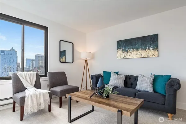 a living room with furniture and a painting