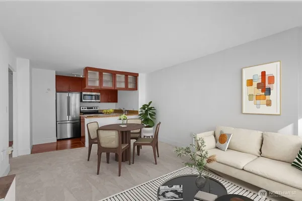 a living room with furniture a rug and a wall painting