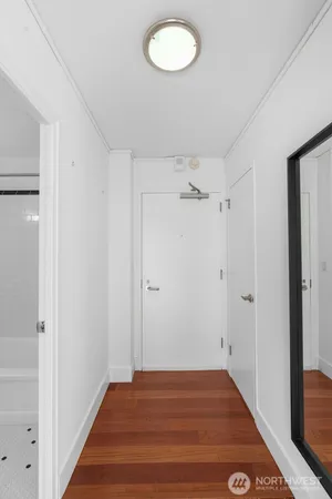 a view of a room with wooden floor and bathroom view