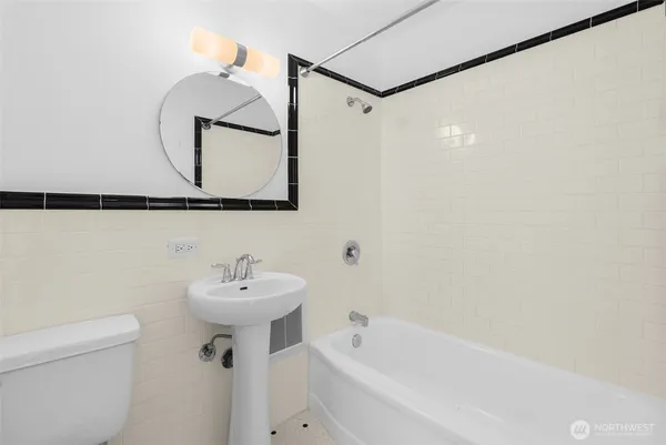 a bathroom with a sink a mirror and a bathtub