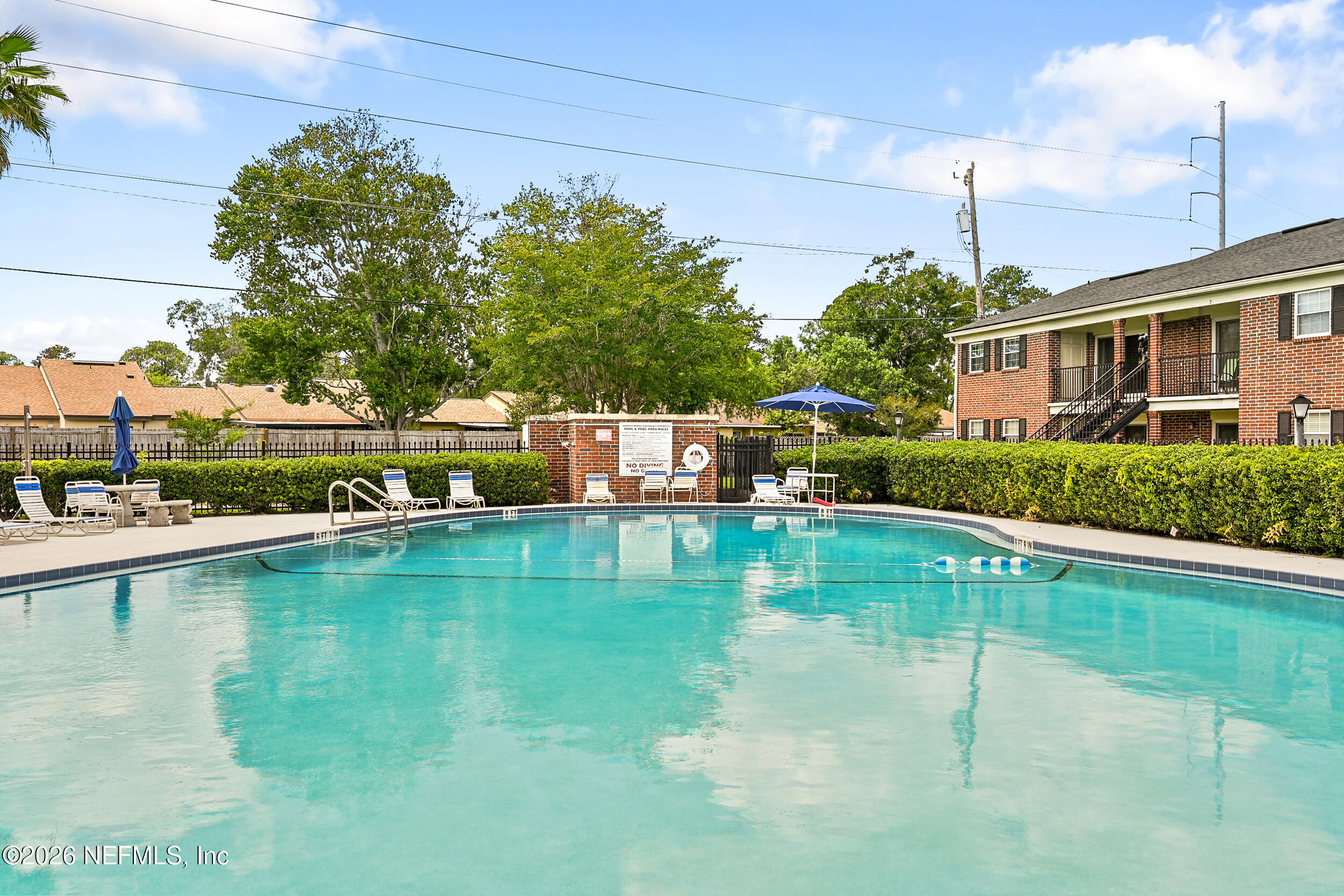 4915 Baymeadows Road, Unit 6G Jacksonville, FL 32217 - Photo 39 of 44 a view of a swimming pool with a garden