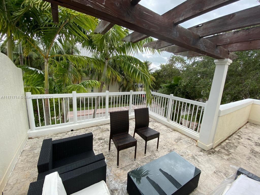 584 Fernwood Road Key Biscayne, FL 33149 - Photo 15 of 24 a view of porch with a bench