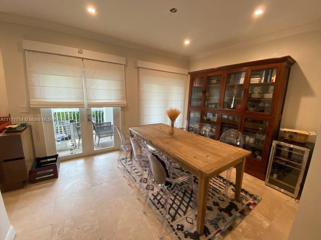 584 Fernwood Road Key Biscayne, FL 33149 - Photo 3 of 24 a dining room with a table and chairs