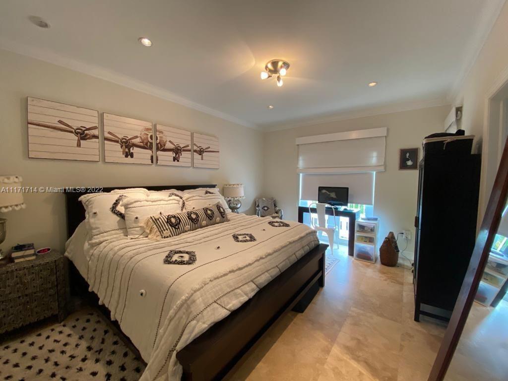 584 Fernwood Road Key Biscayne, FL 33149 - Photo 7 of 24 a view of a bedroom with bed and window