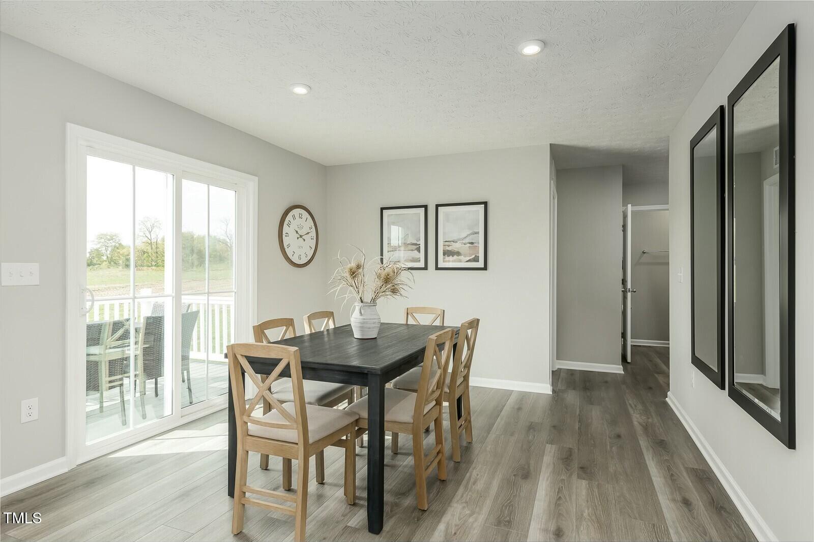 4185 Mantis Court Bailey, NC 27807 - Photo 10 of 20 a view of a dining room with furniture window and wooden floor