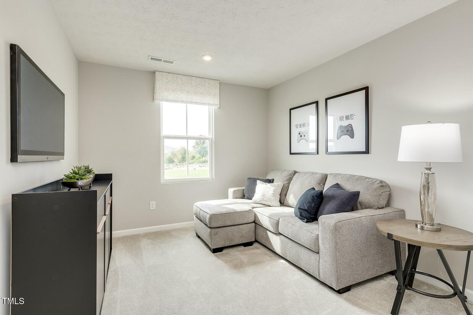 4185 Mantis Court Bailey, NC 27807 - Photo 12 of 20 a bedroom with a bed and a flat screen tv
