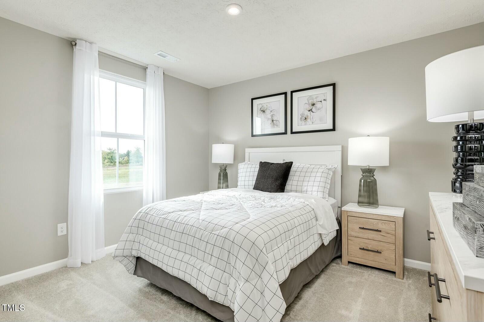4185 Mantis Court Bailey, NC 27807 - Photo 17 of 20 a bedroom with a bed and a lamp