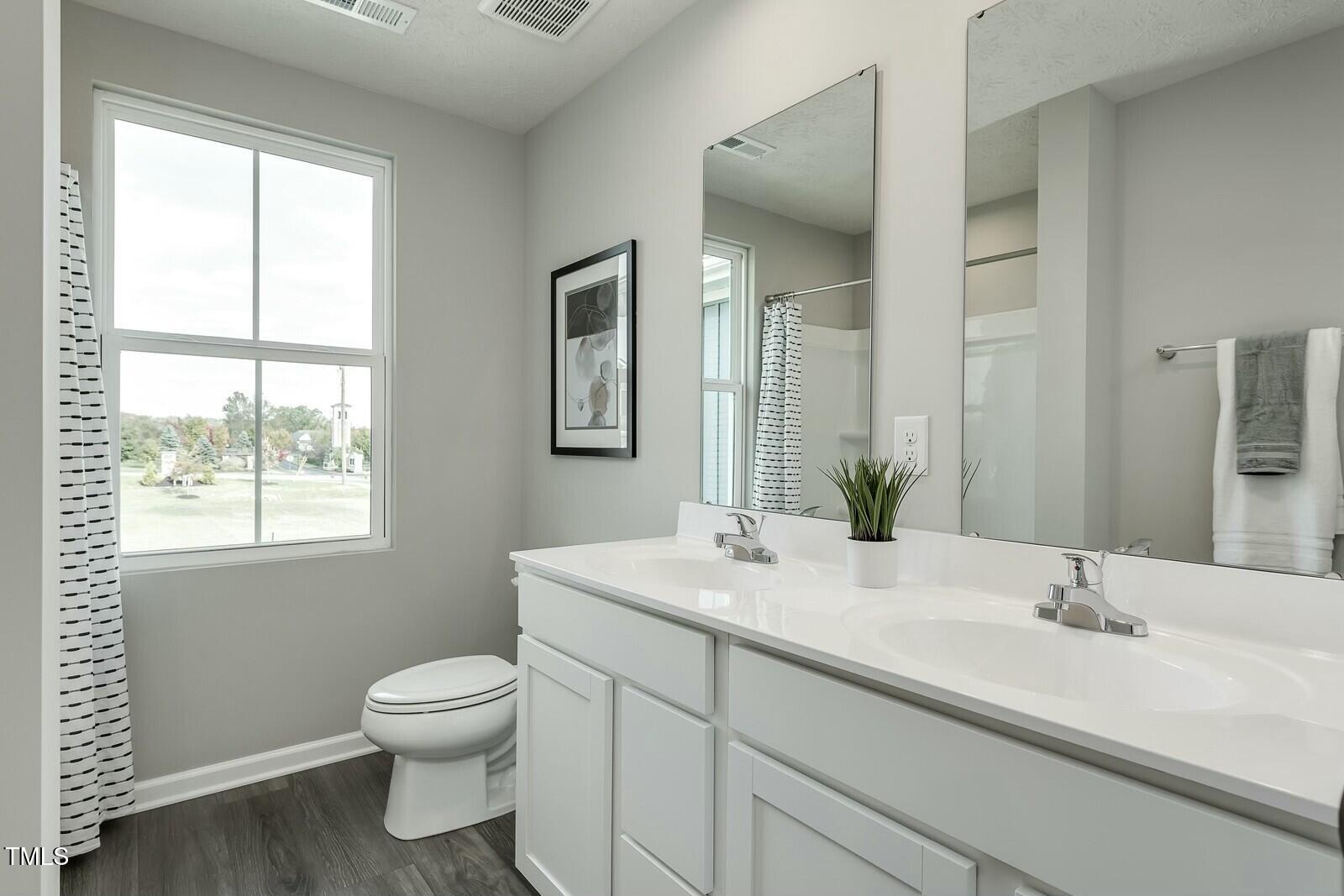 4185 Mantis Court Bailey, NC 27807 - Photo 18 of 20 a bathroom with a sink toilet and a mirror