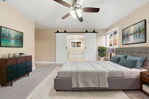 a bedroom with a large bed and a flat screen tv