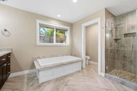 a spacious bedroom with a bed and a window