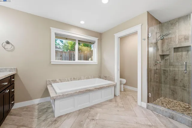 a spacious bedroom with a bed and a window