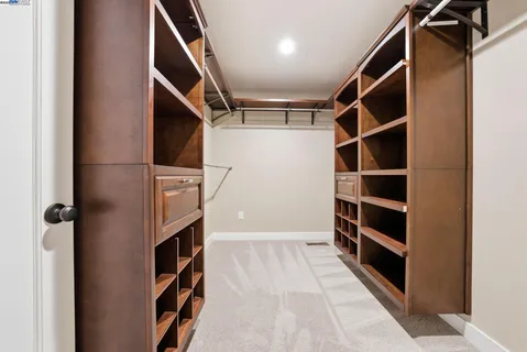 a view of walk in closet with empty racks