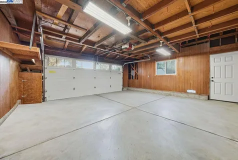 a view of house with backyard and seating area