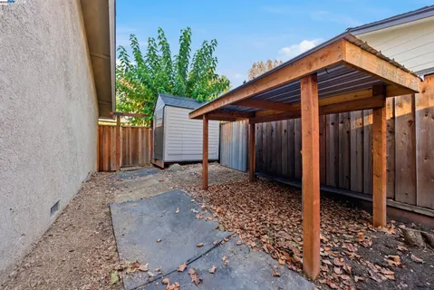 a view of a patio with a table and chairs and potted plants