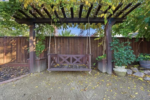 a front view of a house with a yard and tree s