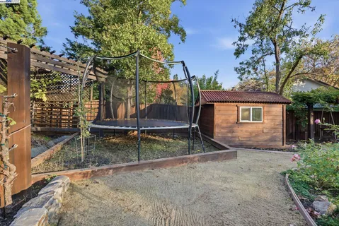 a view of a wooden deck and a backyard