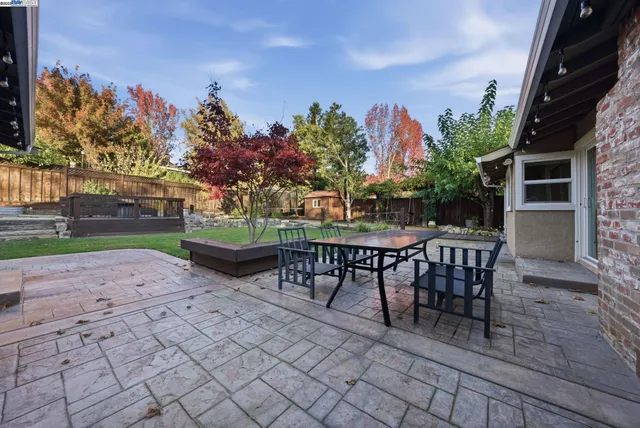 a view of a house with backyard and deck
