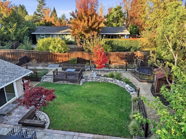 an aerial view of a house with swimming pool and garden