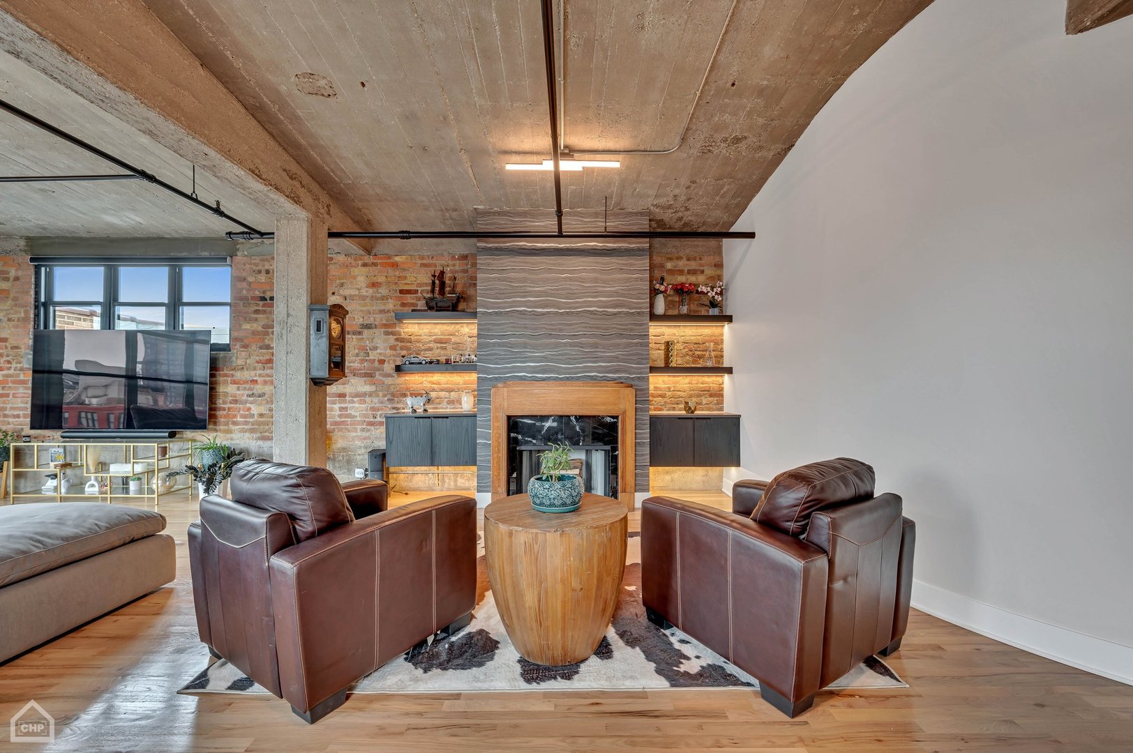 1017 West Washington Boulevard, Unit 7APH Chicago, IL 60607 - Photo 13 of 30 a living room with furniture and a fireplace