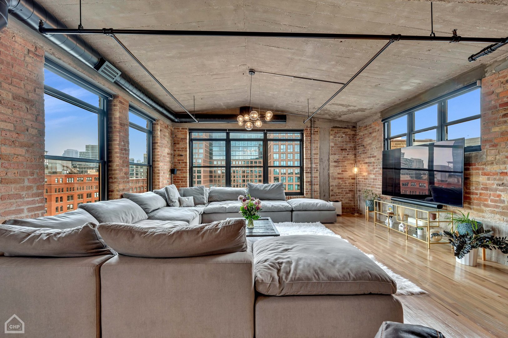 1017 West Washington Boulevard, Unit 7APH Chicago, IL 60607 - Photo 15 of 30 a living room with furniture and a chandelier