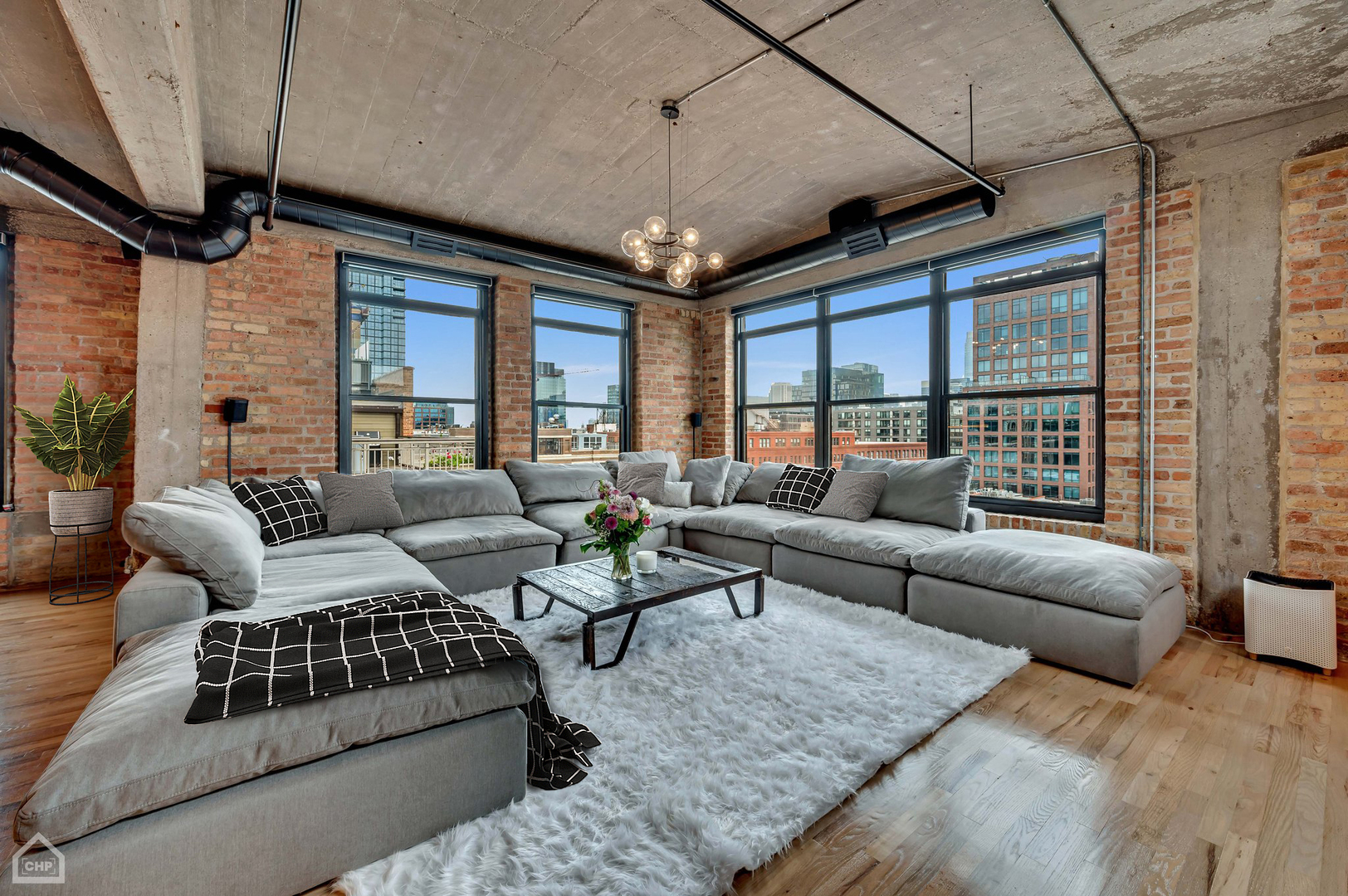 1017 West Washington Boulevard, Unit 7APH Chicago, IL 60607 - Photo 16 of 30 a living room with furniture ceiling fan and a rug
