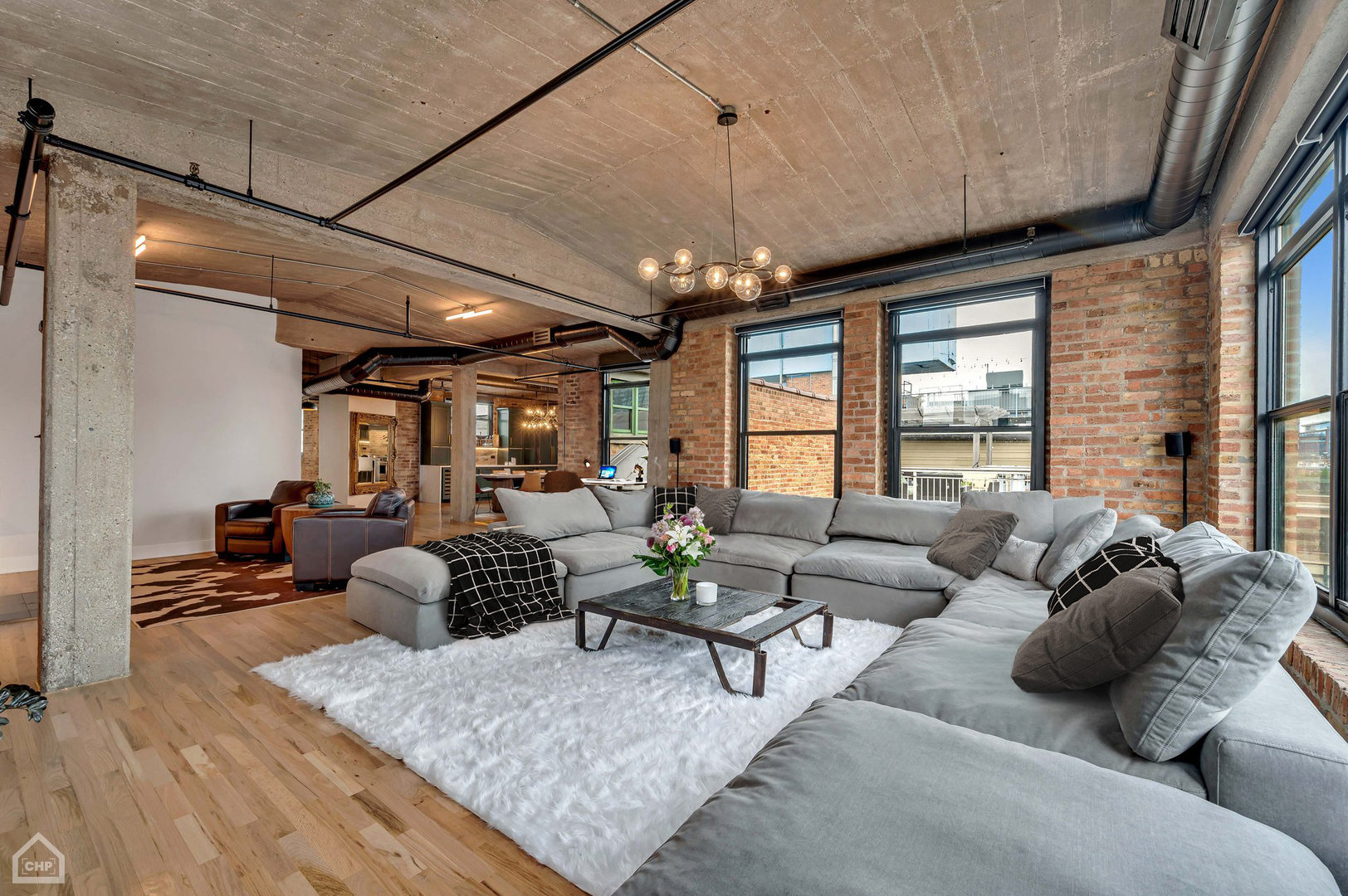 1017 West Washington Boulevard, Unit 7APH Chicago, IL 60607 - Photo 17 of 30 a living room with furniture and a chandelier