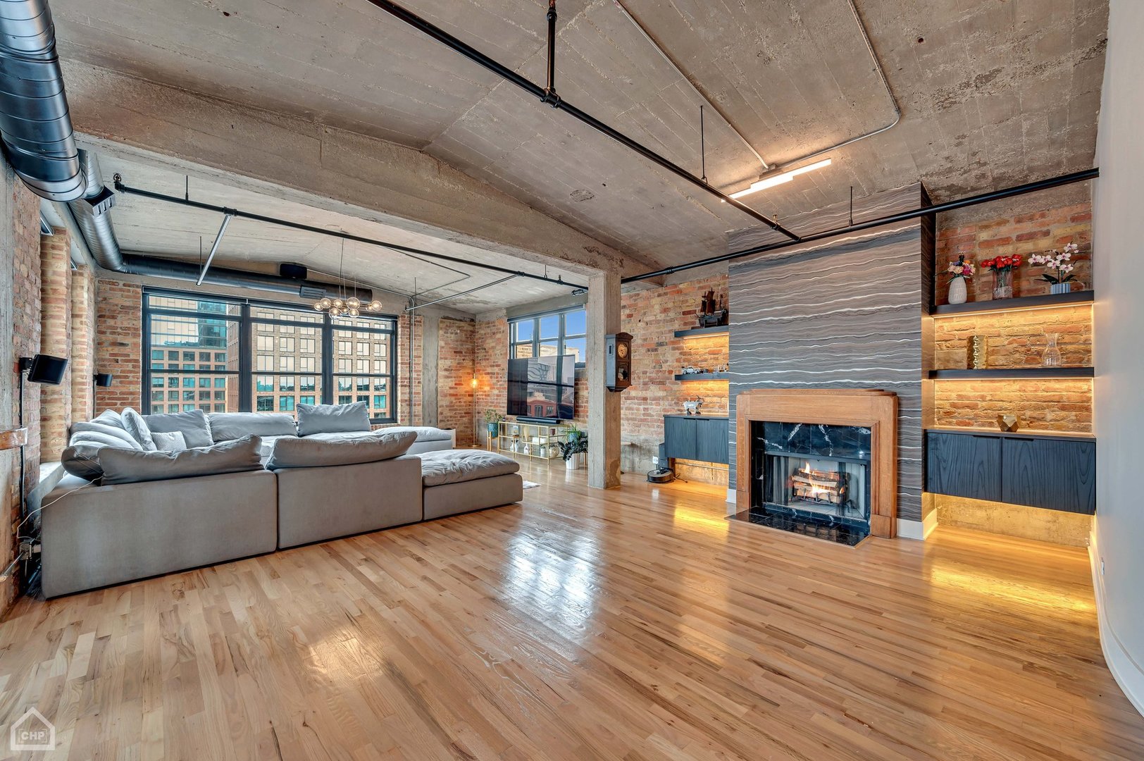 1017 West Washington Boulevard, Unit 7APH Chicago, IL 60607 - Photo 18 of 30 a living room with furniture wooden floor and a fireplace