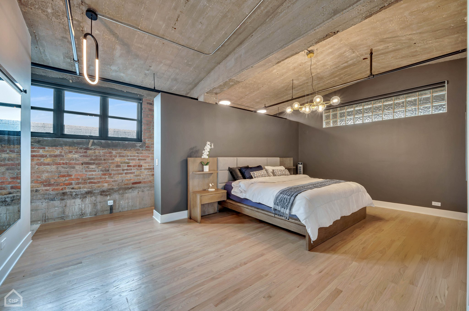 1017 West Washington Boulevard, Unit 7APH Chicago, IL 60607 - Photo 19 of 30 a bedroom with a bed and a flat screen tv