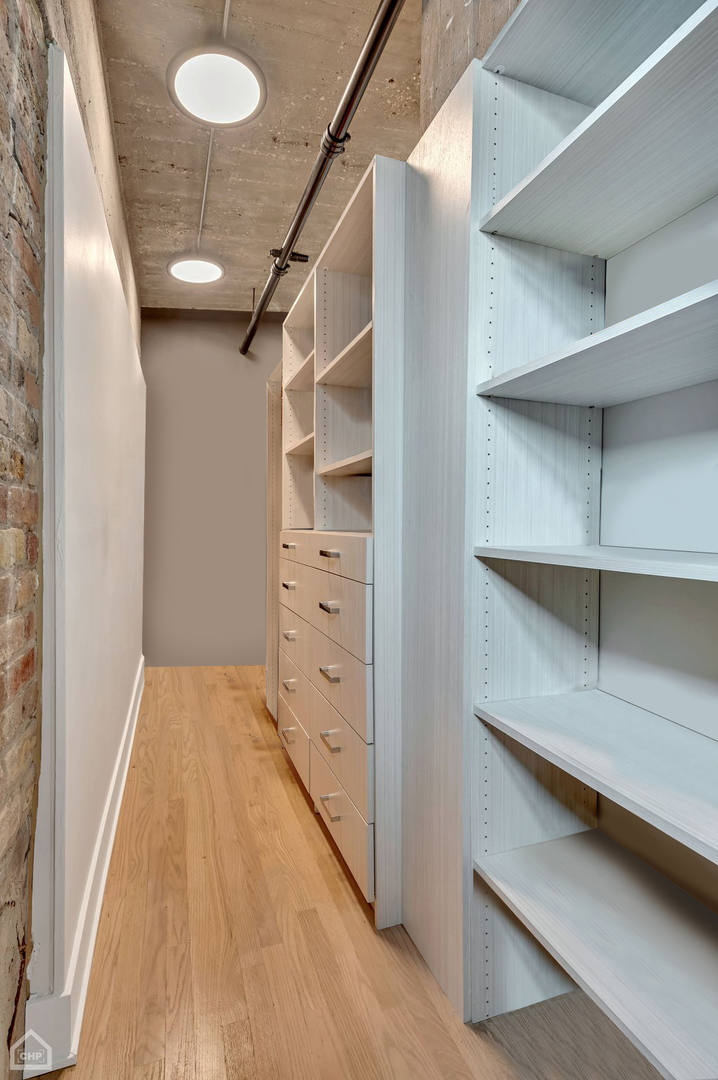 1017 West Washington Boulevard, Unit 7APH Chicago, IL 60607 - Photo 21 of 30 a view of walk in closet with empty racks
