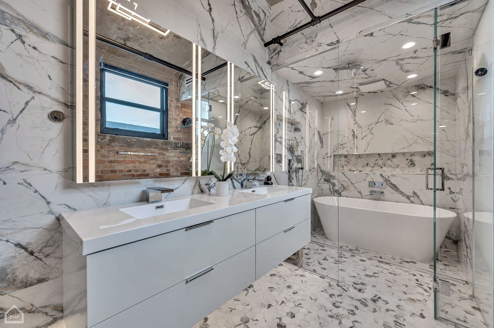 1017 West Washington Boulevard, Unit 7APH Chicago, IL 60607 - Photo 22 of 30 a bathroom with a tub sink and mirror