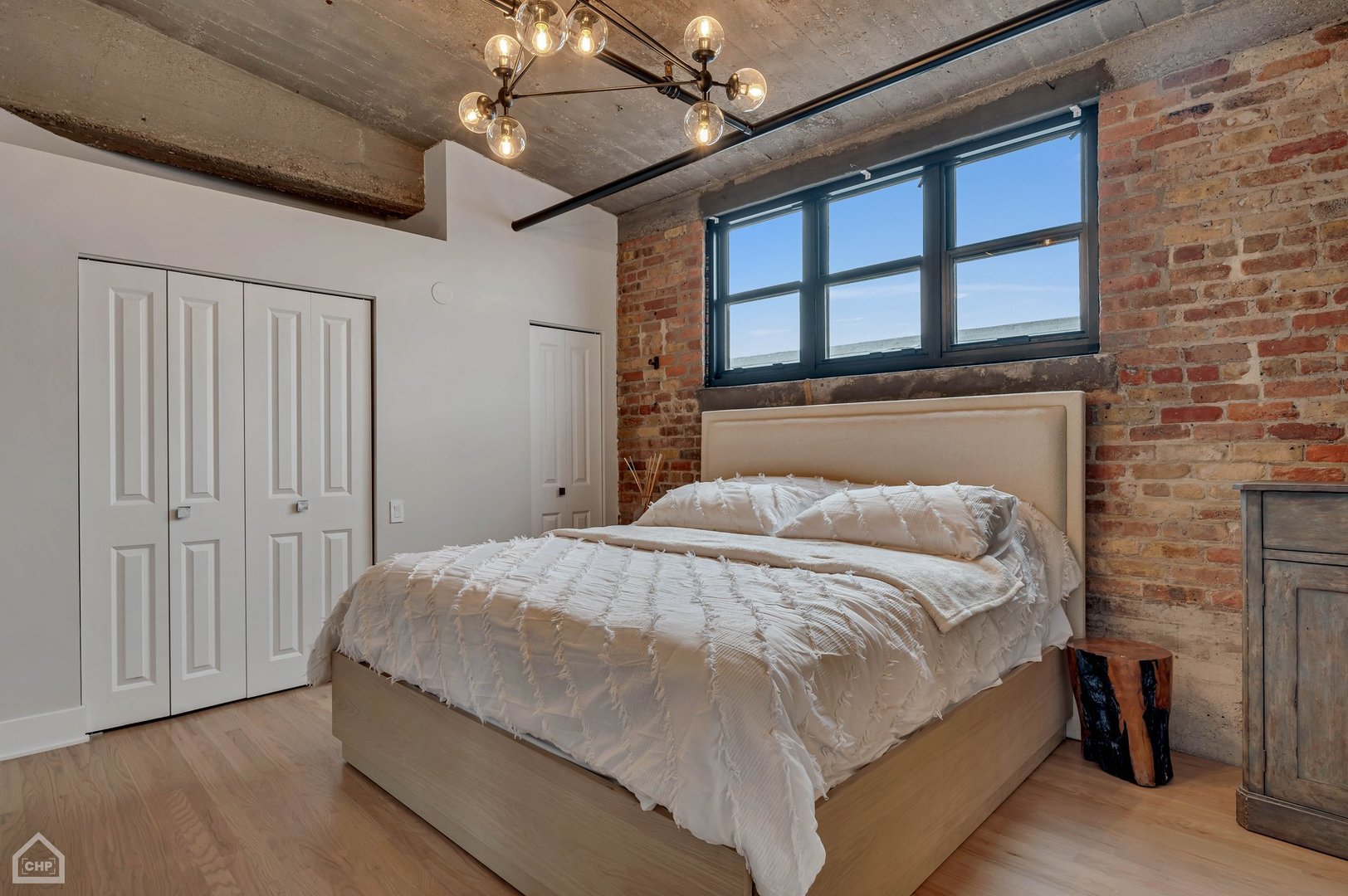 1017 West Washington Boulevard, Unit 7APH Chicago, IL 60607 - Photo 23 of 30 a bed sitting in a bedroom next to a window