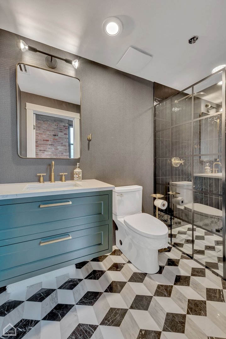 1017 West Washington Boulevard, Unit 7APH Chicago, IL 60607 - Photo 24 of 30 a bathroom with a sink a toilet and shower