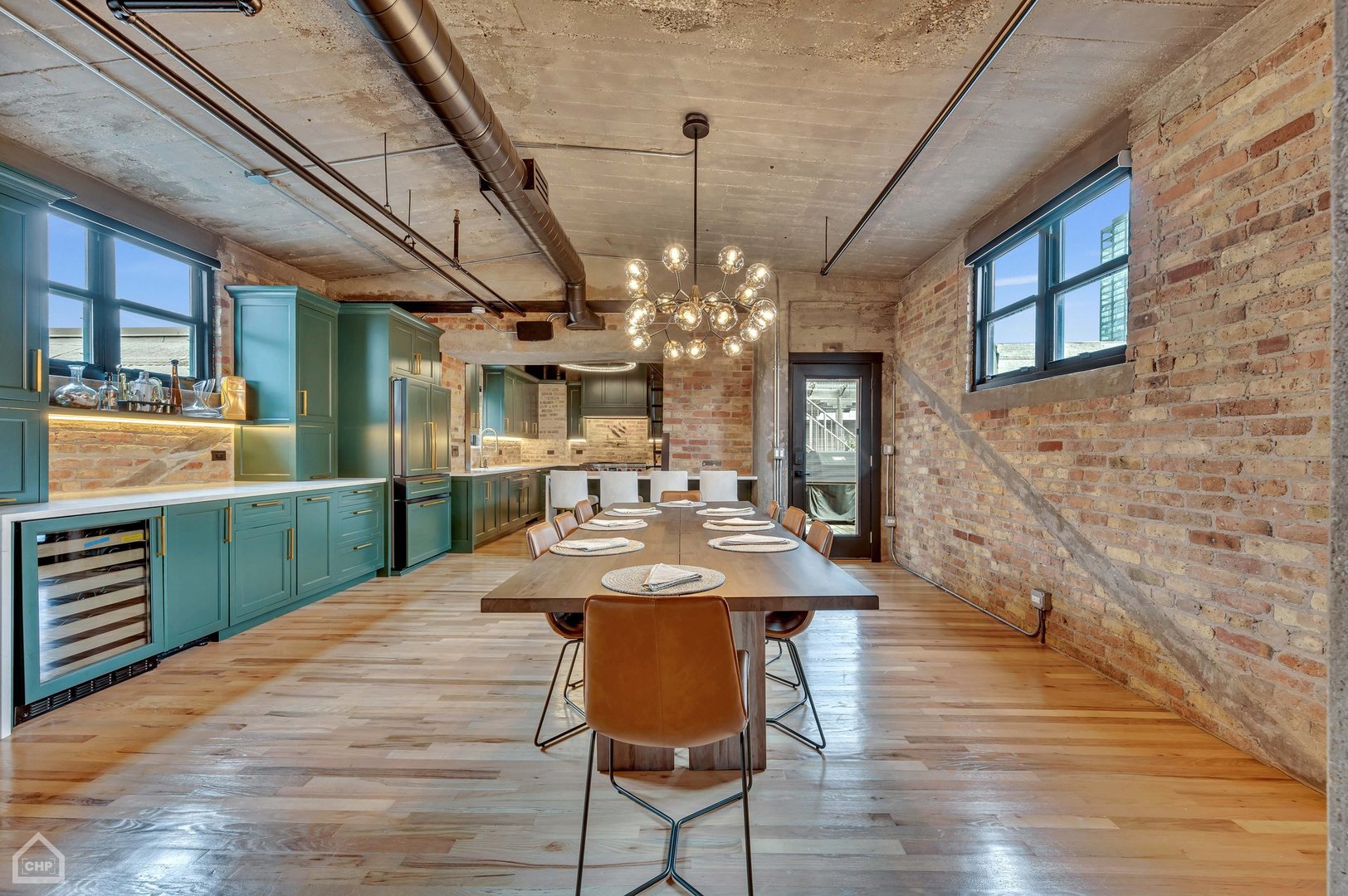 1017 West Washington Boulevard, Unit 7APH Chicago, IL 60607 - Photo 7 of 30 a view of a dining room with furniture a chandelier and wooden floor