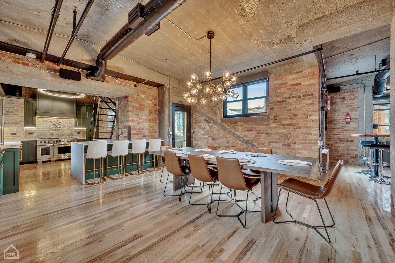 1017 West Washington Boulevard, Unit 7APH Chicago, IL 60607 - Photo 8 of 30 a view of a dining room and livingroom with furniture wooden floor a chandelier