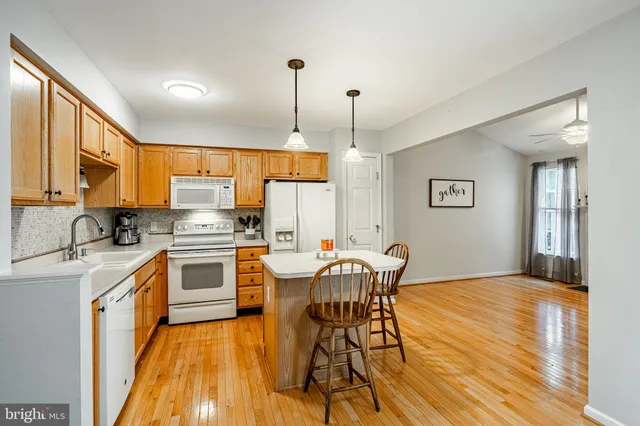a view of a kitchen with a table and chairs
