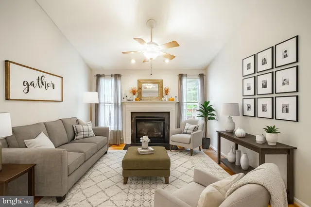 a living room with furniture and a fireplace