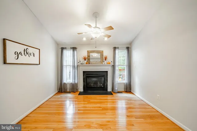 a view of an empty room with window and a fireplace