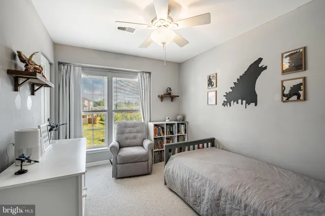 a bedroom with furniture and a large window