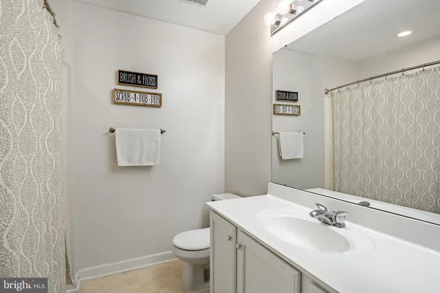 a bathroom with a sink toilet and vanity