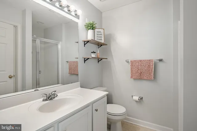 a bathroom with a sink toilet and a mirror