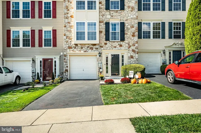 a front view of a building with a garden