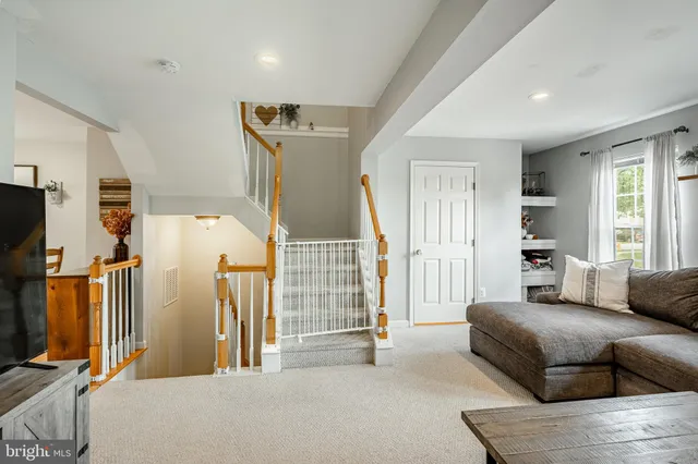 a living room with furniture gym equipment and a flat screen tv