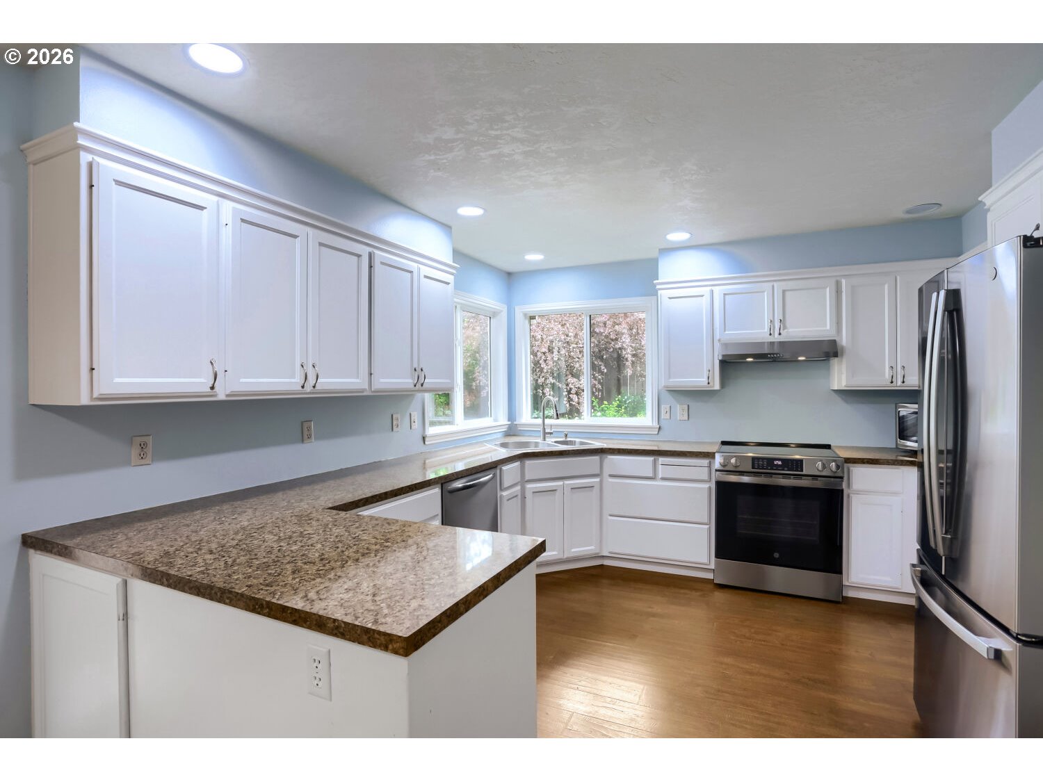 8160 Southwest 147th Terrace Beaverton, OR 97007 - Photo 14 of 31 a kitchen with stainless steel appliances granite countertop a stove a sink and a refrigerator