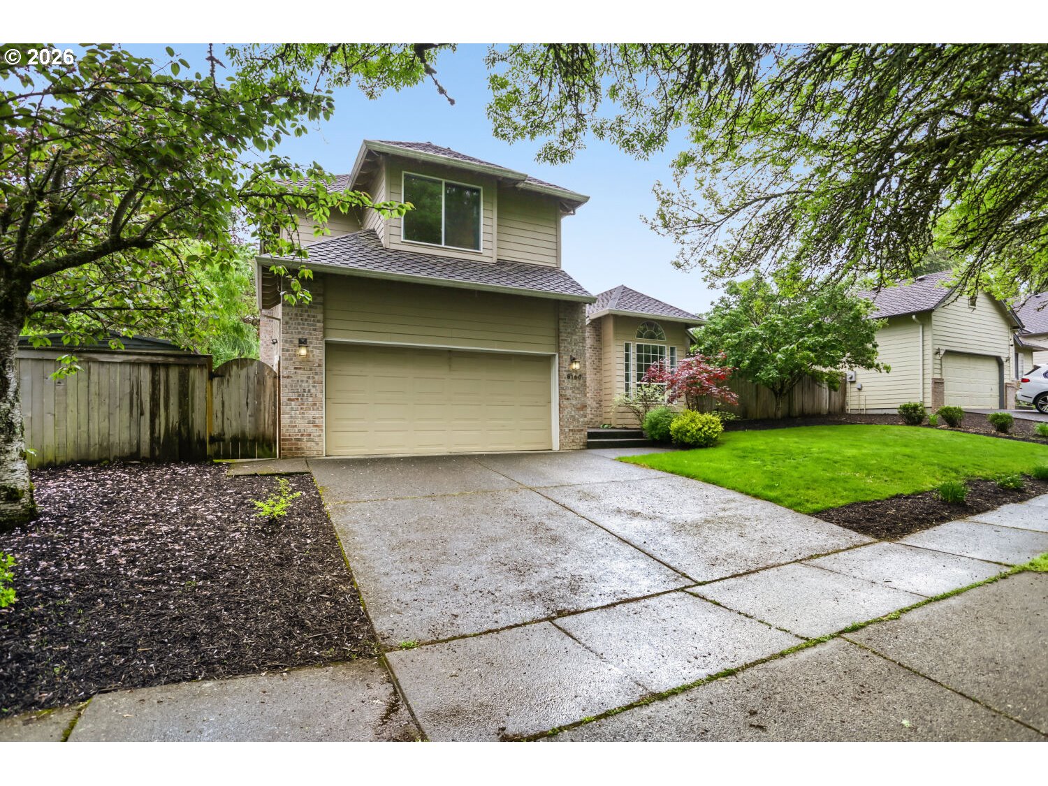 8160 Southwest 147th Terrace Beaverton, OR 97007 - Photo 2 of 31 a front view of a house with a yard and garage