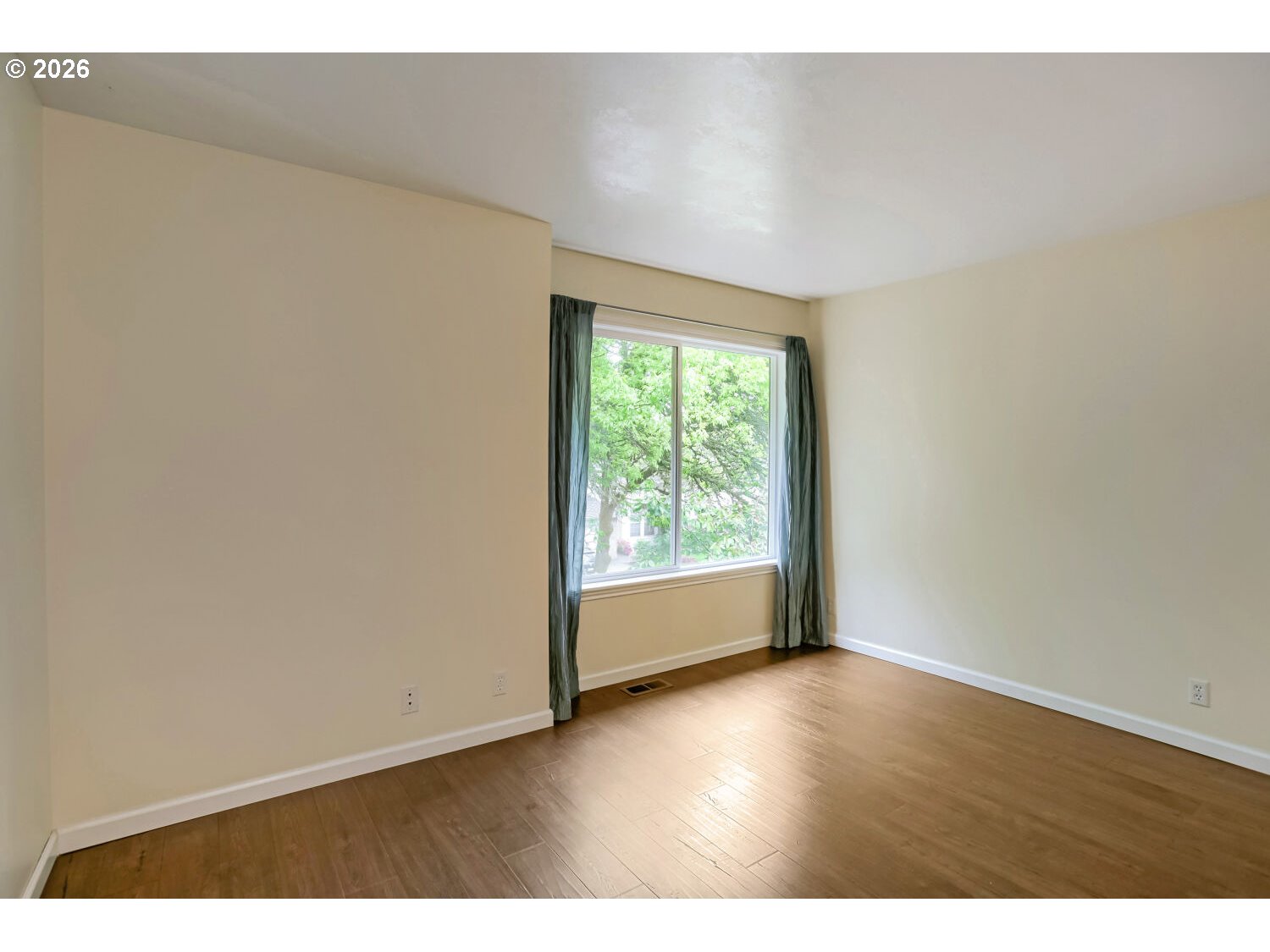 8160 Southwest 147th Terrace Beaverton, OR 97007 - Photo 22 of 31 a view of an empty room with wooden floor and a window