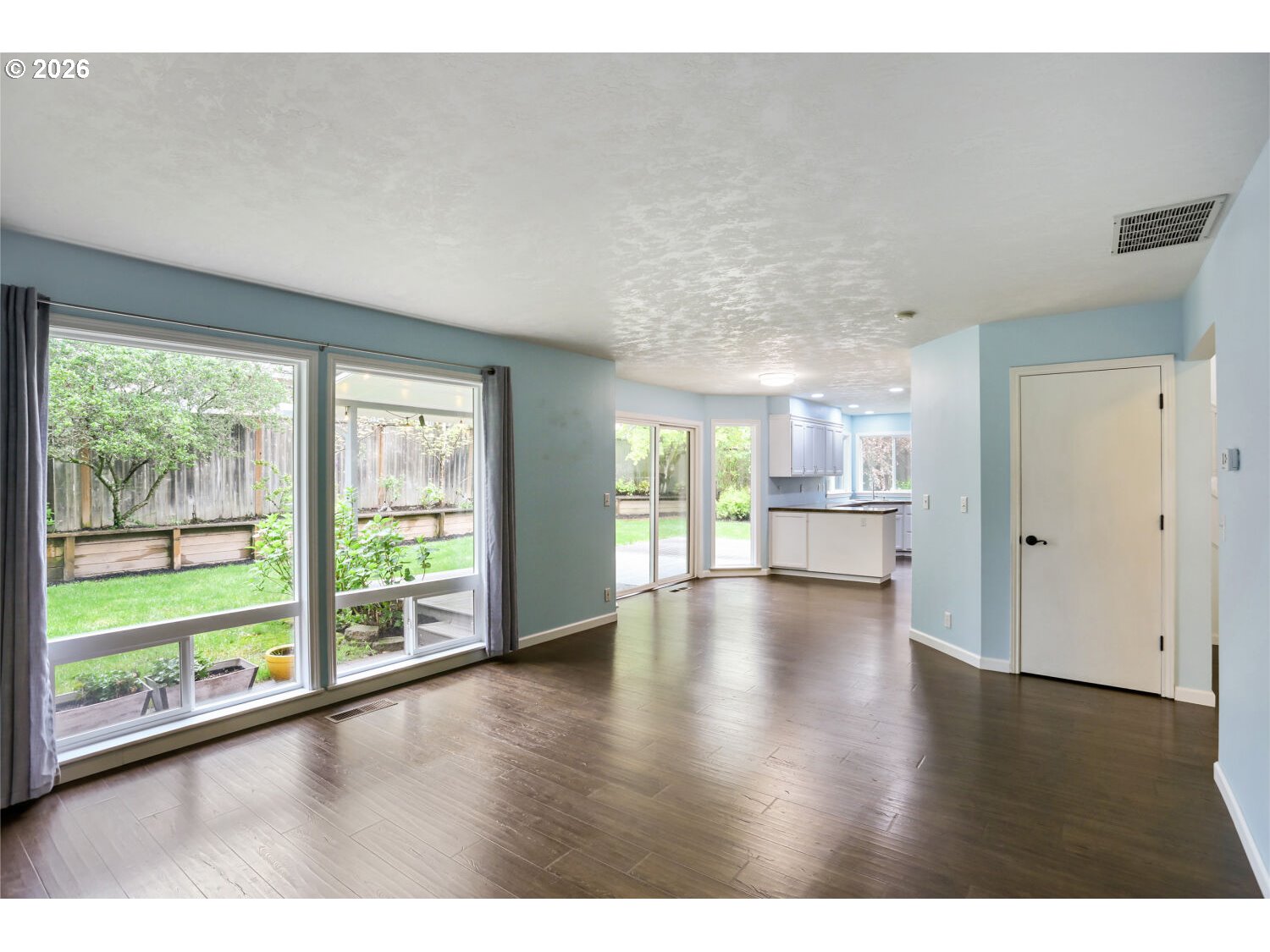 8160 Southwest 147th Terrace Beaverton, OR 97007 - Photo 10 of 31 a view of empty room with wooden floor and windows