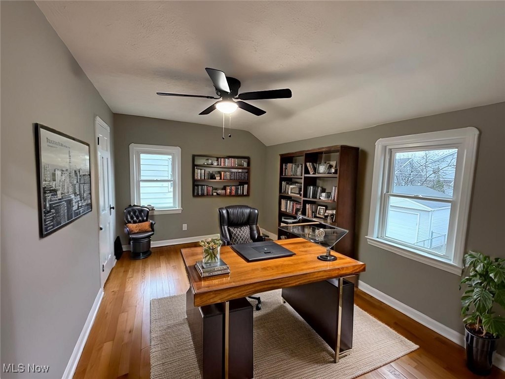 6807 Gerald Avenue Parma, OH 44129 - Photo 17 of 25 Home office with baseboards, lofted ceiling, ceiling fan, and wood finished floors virtually staged