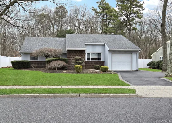 a front view of a house with a garden and garage