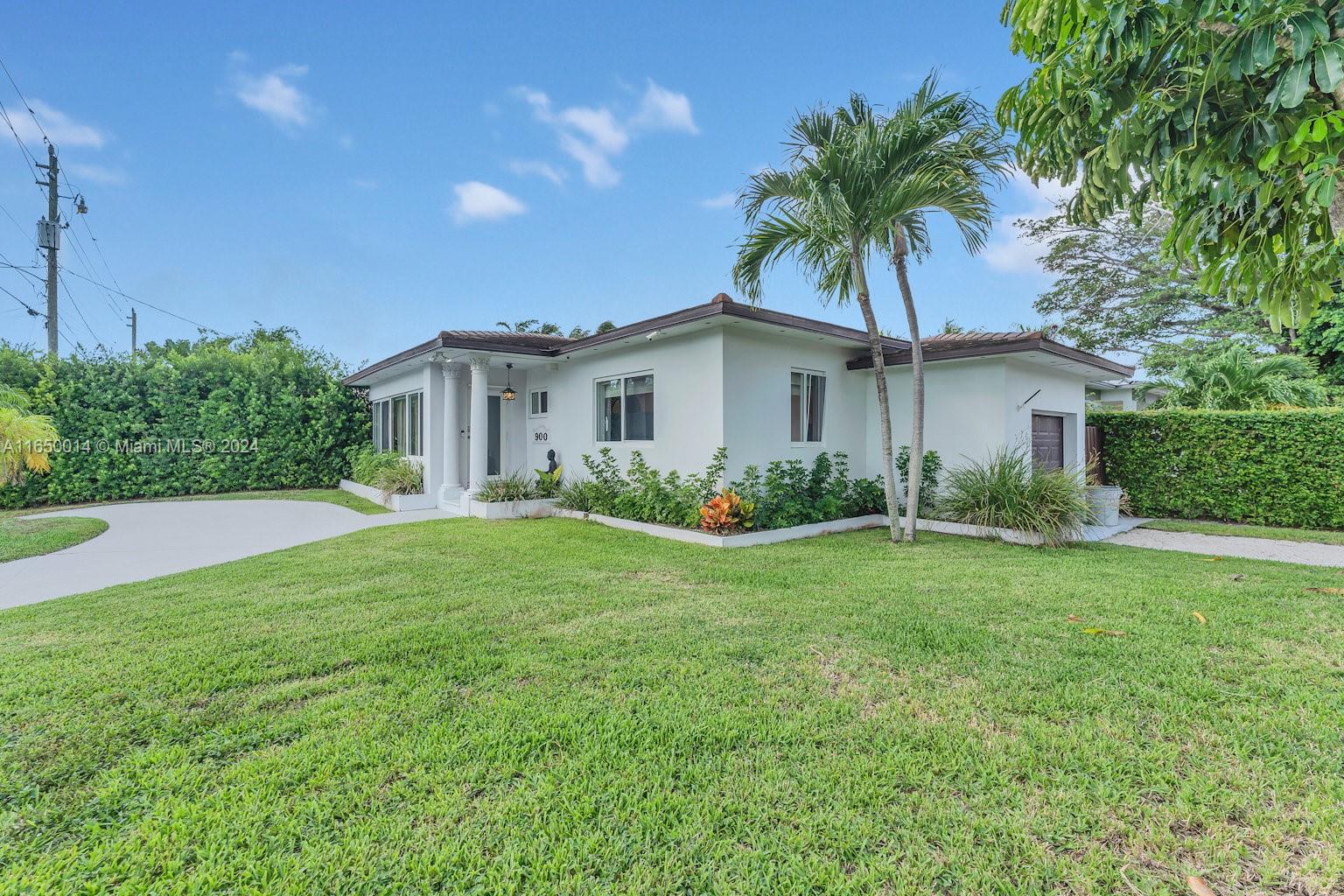 900 Surfside Boulevard Surfside, FL 33154 - Photo 12 of 38 a palm tree sitting in front of a house with a big yard