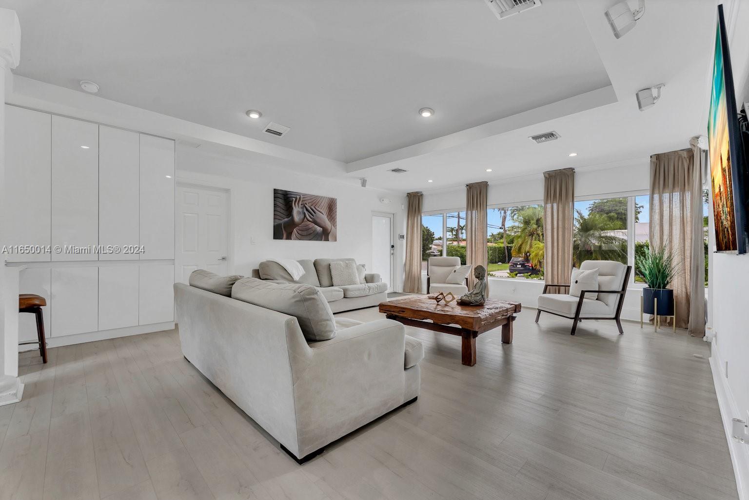 900 Surfside Boulevard Surfside, FL 33154 - Photo 14 of 38 a living room with furniture and a table